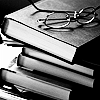 sarcastic_ink: A stack of books in black and white with a pair of glasses on top. (books: black & white)