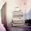 chalcopyrite: A stack of books next to a bed, with a teacup balanced on top (books: bedtime reading)