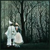 konsectatrix: Detail from Henri Rousseau's Carnival Evening, depicting a male/female couple in clown costume in a dark forest. (carnival evening)