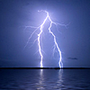 konsectatrix: Lightning at night striking the far shore over otherwise calm water. (lightning on the bay.)