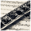 musyc: Silver flute resting diagonally across sheet music (Default)