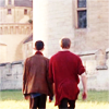 king: Arthur and Merlin walk shoulder to shoulder, viewed from behind. (Ⓜ two against the world)