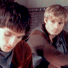 king: Arthur looks across at Merlin working in the foreground, his mouth twisted in thought. (Ⓜ how dyou solve a problem like merlin)