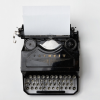 shopfront: Black and white typewriter with a blank page, top down view (Stock - typing down my worlds)
