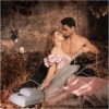 revena: Man and woman embracing in bodice-ripper cliche pose, with a vacuum cleaner (Romance)