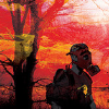 auto_destruct: a person in a gas mask with a backpack against a red sunset (sunset)