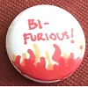 redbird: a pin with the text "Bi-Furious" above a drawing of flames. (bi-furious)