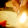 annariel_dw: A hand writing by candlelight. (Default)