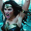 anaraine: Diana of Themyscira, dressed in armor with her arms raised above her head (lifting a tank), mouth opened to shout. ([wonder woman] fight like a girl)