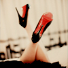 ampersandjay: Photo of a woman lying face down on a bed, only her crossed legs with black high heels are visible (Default)