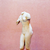 flewbetween: Nude statue of a woman with the arms broken away on a pink background. ((art) statuesque)