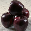 applewatcher: Four very dark red apples, stacked in a pyramid (Default)