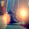 outlineofash: The setting sun highlights a pair of legs clad in jeans and sneakers. (Gentle - Converse)
