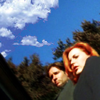 venusundae: mulder and scully with a bright blue sky above them in the woods (０７８ (a false accusation under blue skies)