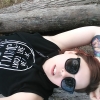 crimisin: A picture of me laying on a tree branch, I am wearing big sunglasses and a tank-hoodie that says never trust the living, (blackcraftcult, selfie, visible tattoo, witch tattoo)