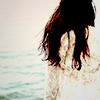 fullupwithfire: a person standing with their back to the camera, long hair loose, staring out into a body of water (pic | it calls me)