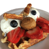 wafflelate: a waffle with an angry face made out of other foods (mad)