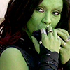 sciatrix: Alien woman Gamora hides her expression behind her fingers as she side-eyes someone to her far right. (side-eye)