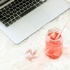 sesquidrabbles: Glass jar filled with some red liquid lying next to a white laptop, a few red paper clips lying by its side (Sesquidrabbles Icon)