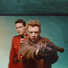 seraphina_snape: icon of Benton Fraser and Ray Kowalski from the show Due South. Ray is pointing his gun, Fraser is standing behind him. The background of the image has been replaced by a green texture. (dueSouth_ RayK+Fraser)