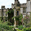 anghraine: a stone manor amidst green climbing plants (haddon hall)