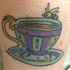 shinyhappygoth: tattoo of a teacup with a honeybee perched on the rim (tattoo)