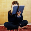 flyakate: woman reading a blue book (wrapped up in books)