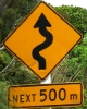 crazyscot: Sign warning of a winding road (winding road)