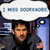 esteefee: John Sheppard in his BDUs, sitting at a table in the Atlantis conference room with a thought bubble above his head, caption in comic font -I MISS DOORKNOBS- (doorknobs)