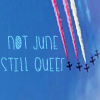 muccamukk: Blue sky with aeroplanes trailing red, orange, yellow, green and blue smoke. Text: "Not June. Still Queer." (Misc: Still Queer)