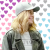 mlravenwrites: Captain Marvel in leather jacket and baseball cap, grinning in front of background of rainbow hearts. (captain marvel queer rainbow hearts)