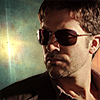 esteefee: Vegas!John in aviators against a turquois background with a flaring star. (vegas)