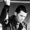 muccamukk: Frank holds onto the bar above a hospital bed, attempting to look casual. (Twelve O'Clock: Bed)