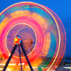 supermagpie: A long exposure picture of a ferris wheel depicting it as a big wheel of fast-spinning rainbow light. (rainbowspin)