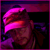 eriktrips: me in hat, pink light (Default)