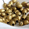 mergatrude: a bowl of gumnuts that have been sprayed with gold paint (xmas gumnuts)