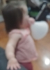 crystalpyramid: blurry picture of a one year old, seen from behind, holding a white plastic funnel like a megaphone (megaphone)