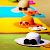 welogorita: Line of colorful hats with sunglasses on them, all placed over beach towels (Hats with sunglasses)