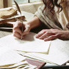 lirazel: A close up shot of a woman's hands as she writes with a quill pen ([film] scribbling)