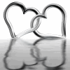 machinaperegrina: Two entwined silver hearts being reflected by water in movement (Entwined hearts)