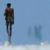 afrikate: Namibian tribesman (San, I think), walking away into the desert (namib desert)