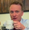clarasteam: Jamie Parker looking surprised and holding a High Society mug (Parker mug)