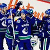 monksandbones: A photo of a group of Vancouver Canucks ice hockey players wearing blue and green home jerseys, celebrating a goal (canucks of vancouver superior warriors)