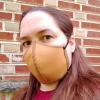 aphowell: Photo of the author in a mask taken outside in front of a brick wall (mask)