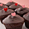 topaz119: photo of chocolate cupcakes with chocolate glaze and decorated with small, upstanding heart candies (cupcakes are love)
