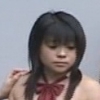 futamura_neo: The head and bare shoulders of a young Japanese woman wearing a red bowtie. A hand rests on her right shoulder. (Default)