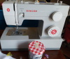 camwyn: A gray sewing machine with the Singer logo on its knob (sewing machine)
