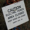 sara: Photo of a sign saying, "Caution: electric fence.  Area closed." (do not)