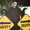 muccamukk: Two road signs pointing opposite ways reading "Safety" and "Death." A shrugging grim reaper stands between them. (Misc: Safety or Death!)