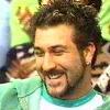 frausorge: Joey Fatone in a green jacket, looking down and smiling broadly (the inward eye)